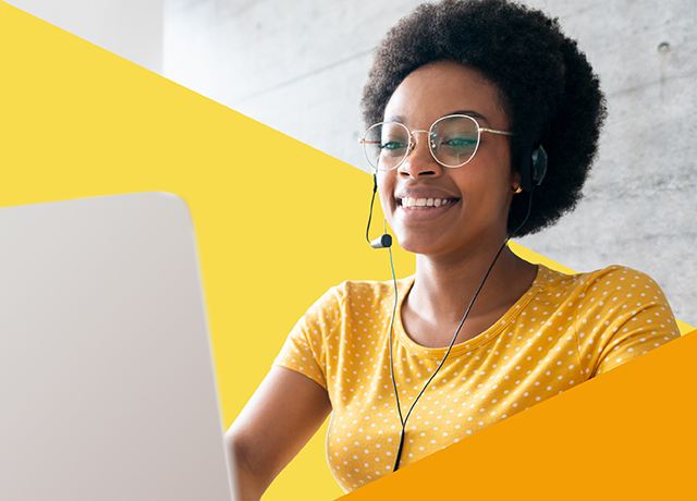 Person with headset using laptop, representing online English testing.