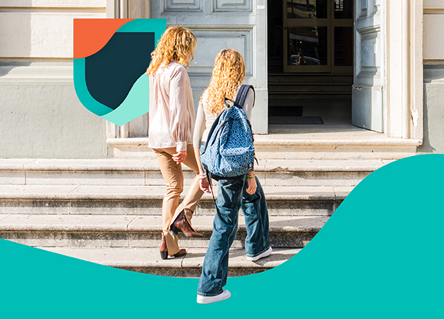 Two people walk into an academic building, symbolizing global access to education through Cambridge English Qualifications.